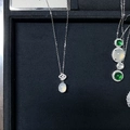 Detailed macro of a silver necklace featuring an oval white gemstone and pave-set bail - White Chalcedony (XL186)