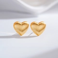 Detail of matte heart-shaped gold earrings with brushed metallic texture and 3D design - Heart (ED217-T)