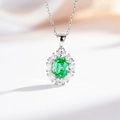Detailed view of an oval emerald green gemstone pendant with a sparkling zircon halo - With Chain / Para Green (XL046)