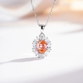 Detail of silver necklace featuring an orange-pink oval gemstone in a petal halo setting - With Chain / Pink Diamond (XL047)