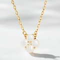 Macro view of gold clover necklace with white mother of pearl inlay and center zircon - Mother of Pearl Necklace (XL416-T)