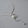 Dettaglio della collana regolabile con perle e catena snake con grande ciondolo tondo - Argento