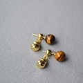 Detailed close-up of a golden gourd earring featuring a natural tiger eye stone bead - Tiger's Eye Style / Gold