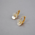 Detail of clover earrings with white shell petals and a sparkling center crystal - Leverback Style