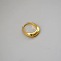Detailed close-up of a polished gold dome ring with a minimalist thick curved design - US 7 / Gold