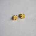 Macro detail of gold-plated clover earrings with a unique hammered texture surface - Four-Leaf Clover