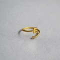 Macro shot of adjustable gold letter E ring with a sparkling clear cubic zirconia stone - Alphabet Style E