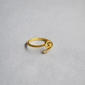 Close-up of golden adjustable ring featuring a letter G design with a sparkling crystal - Alphabet Style G