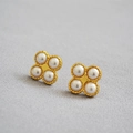 Elegant gold brass clover earrings featuring four lustrous pearls with textured borders - Gold