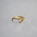 Macro detail of gold-plated open ring with letter H design and small zircon accent - Alphabet Style H