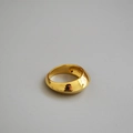 Detail view of a wide gold-plated brass ring with high-polished mirror finish - US 6 / Gold