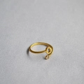 Detail of adjustable gold ring featuring an open letter O and a sparkling zircon stone - Alphabet Style O