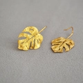 Macro view of matte gold monstera leaf earrings with intricate hollowed vein details - Monstera Leaf (Style 2)