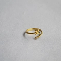 Macro shot of minimalist gold adjustable ring featuring a letter X and a small zircon - Alphabet Style X