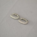 Macro shot of silver U-shaped earrings featuring micropave set sparkling cubic zirconia stones - Silver Pave Zirconia U-Shaped Huggie