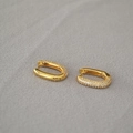 Close-up of golden U-shaped hoop earrings with three rows of micro-pave white zircons - Gold Pave Zirconia U-Shaped Huggie