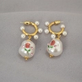 Close-up of baroque pearl earrings with rose prints and sparkling pink rhinestones - Rose Printed