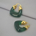Macro detail of dark green translucent resin U-shaped earrings with gold metal accents - Green