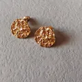 Detailed close-up of textured gold stud earrings with April white crystal stone insert - 1.5cm-April White