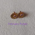 Close-up of golden hammered round earrings featuring a purple February birthstone center - 1cm-February Purple