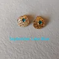 Detail of September Lake Blue gemstone earring with textured gold-tone metal finish - 1cm-September Lake Blue