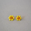 Macro view of handmade yellow enamel camellia flower stud earrings with gold stamen detail - Yellow
