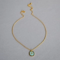 Macro detail of golden palm tree pendant with blue enamel and lobster clasp closure - Chain Style