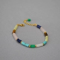 Macro shot of colorful bohemian gemstone beads with gold spacers and lobster clasp - Bracelet