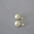 Macro shot of 925 silver large pearl stud earrings with clear silicone backings - 12mm / 620 Color Style