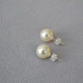 Macro view of large round faux pearl studs with 925 silver pins and silicone backs - 10mm / 620 Color Style