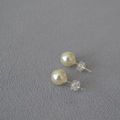Macro shot of large high-luster faux pearl studs with silver pins and silicone backs - 8mm / 620 Color Style