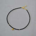 Elegant black spinel beaded necklace with gold cross pendant and lobster clasp for women - Black Beaded Gold Cross Pendant Style