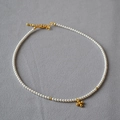 Minimalist pearl necklace with cross pendant and golden beads on grey textured surface - Gold Cross Style (MYN0205-GD-Bai)