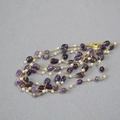 Detail of purple amethyst beads and white freshwater pearls on a gold chain necklace - Purple Stone
