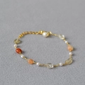 Close-up of gold chain necklace with colorful semi-precious stones and small white pearls - Bracelet / Colorful