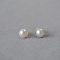 Elegant 925 sterling silver freshwater pearl stud earrings on minimalist fabric background - Approx. 7-8mm
