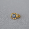 Macro shot of square faceted multi-color fluorite gemstone with vintage gold rope texture - Greenish Fluorite