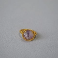 Detailed macro of a gold vintage ring featuring a faceted purple natural stone inlay - Purplish Fluorite