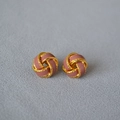 Close-up of vintage twisted knot stud earrings with gold plating and dusty pink enamel - Dusty Pink