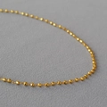 Minimalist faceted gold beaded necklace for women with shiny round brass spheres - Gold