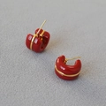 Detailed close-up of red enamel C-shape hoop earrings with gold-line accent and metallic finish - Dark Red