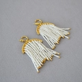 Bohemian gold-plated earrings featuring white bead fringe tassels on textured fabric - Gold White Beaded Tassel Style