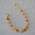 Macro detail of gold plated brass chain with colorful tourmaline beads and lobster clasp - Bracelet