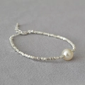 Dettaglio del bracciale a perline argentate con perla centrale e chiusura a moschettone - Rombo + Perla Bianco Sporco