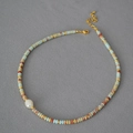 Exotic blue patterned stone beaded necklace with white pearl and gold clasp - Necklace