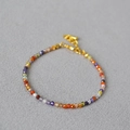 Detailed view of faceted natural stone and pearl beaded bracelet with gold chain - Colorful Zirconia Style