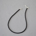 Close-up of black onyx beaded necklace with silver lobster clasp and adjustable chain - 3mm