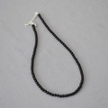 Elegant black agate beaded necklace with silver lobster clasp on minimalist gray fabric - 4mm