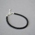 Detail of beaded black onyx bracelet showing silver lobster clasp and extension chain - 3mm / Black Agate