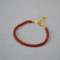 Detail of 3mm red agate beaded bracelet with adjustable gold lobster clasp and extension - 3mm / Red Agate
